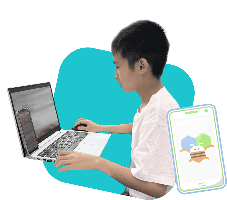 Boy coding a mobile app using AppInventor during a class at RoboCode Academy.